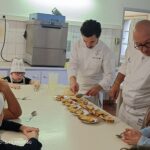 Franck Putelat, Alexis Pocinho et 4 enfants autour d'une table préparent les profiteroles